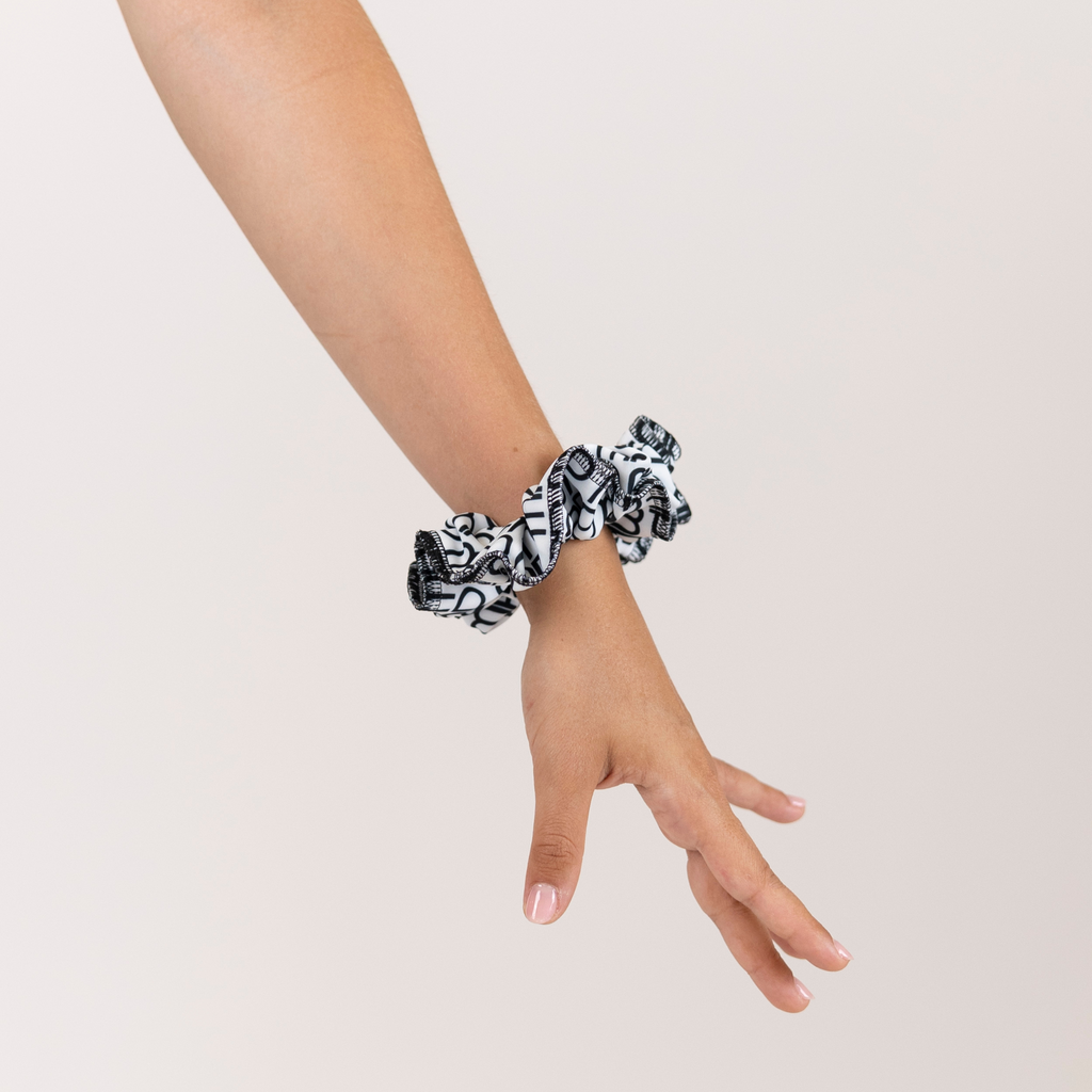 Girl with Black and White Loop Scrunchie on wrist.