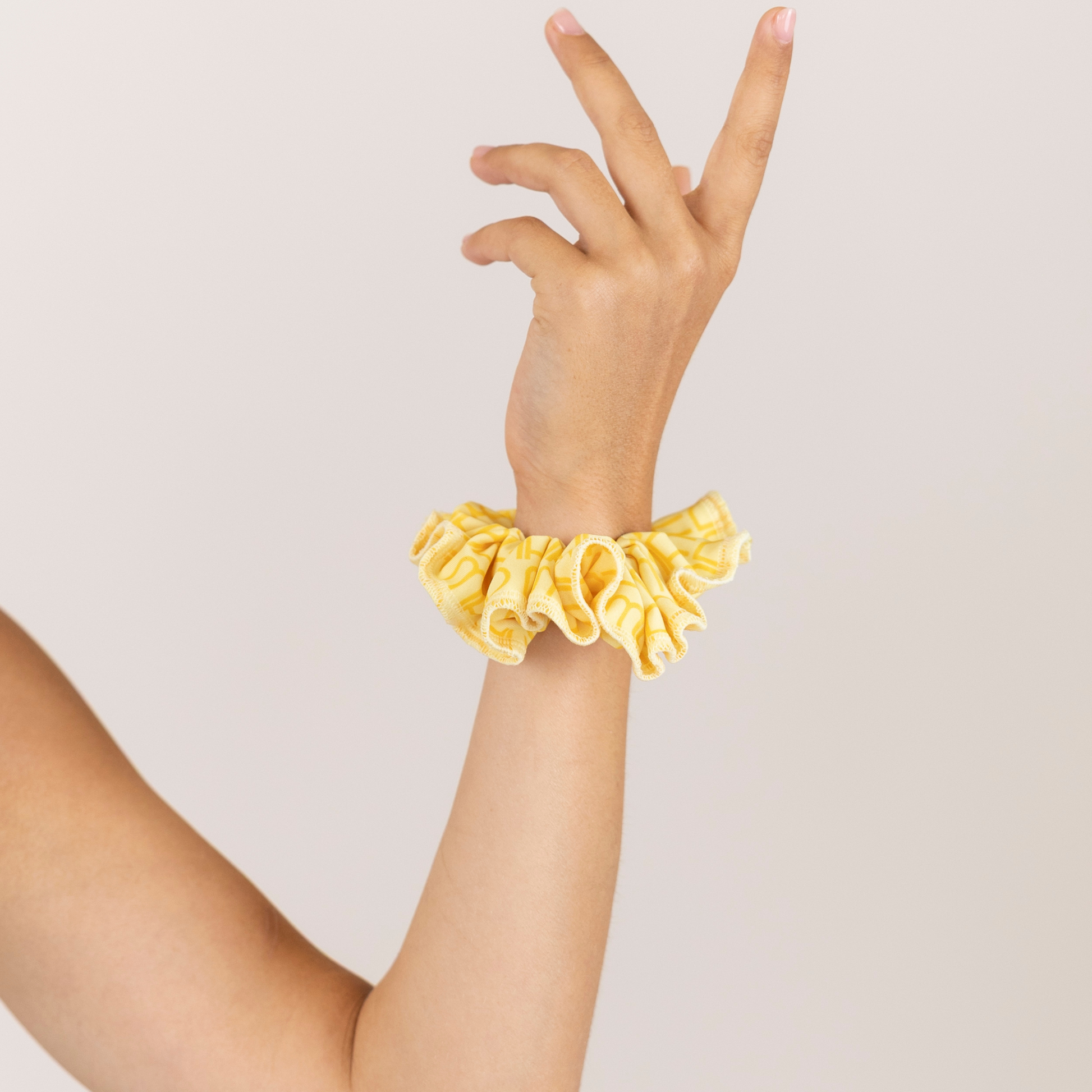 Girl with Butter Yellow Loop Scrunchie on wrist.