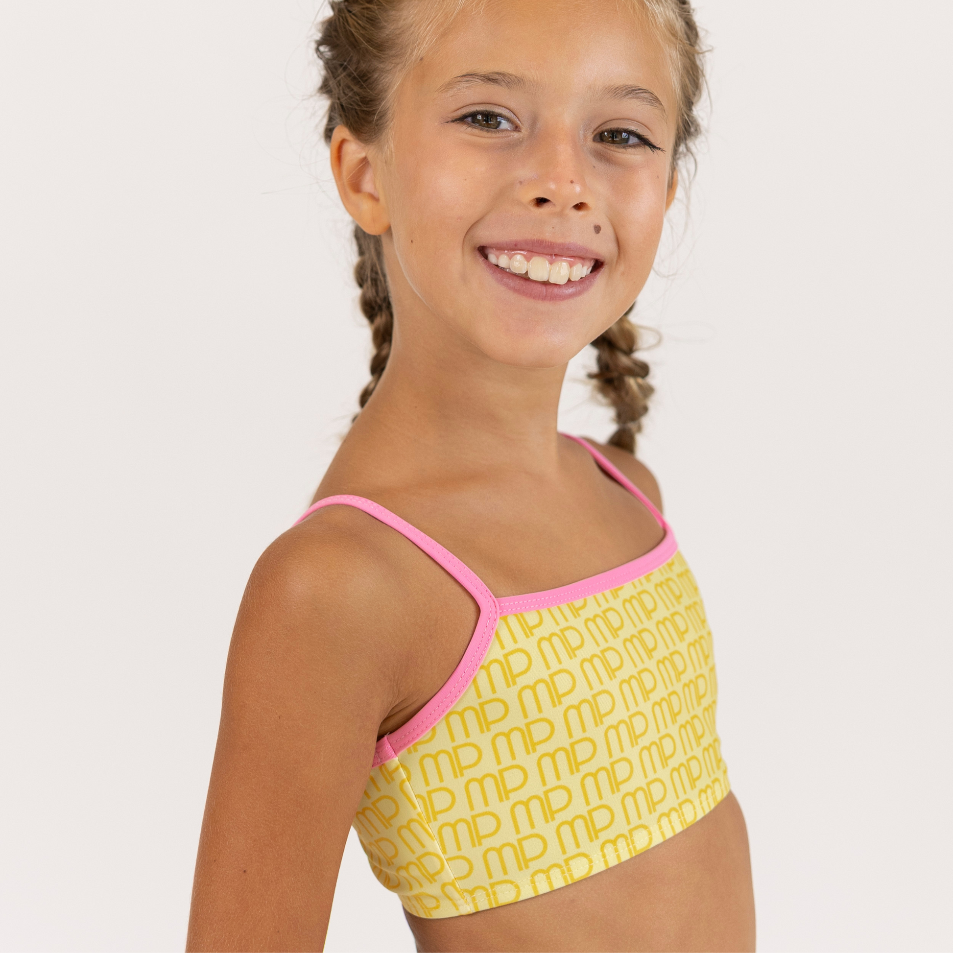 Girl showing right side of Yellow Pudding MP Pattern Crop Top